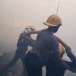 Men of the Kwara state Fire Service working to minimize the effect of fire incident at Ile Oba Ologun in Ita-Amadu area of Ilorin, Kwara state on Friday night