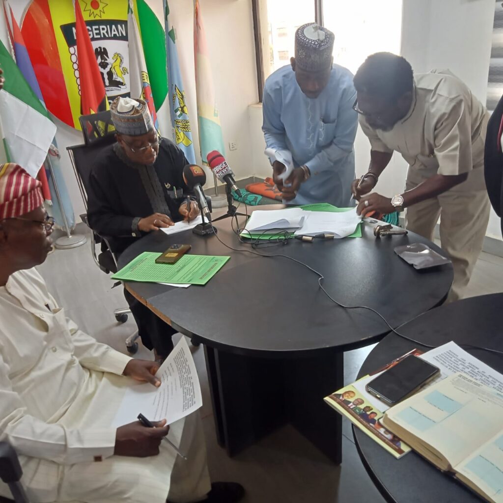 Major General Abdulmalik Jibril (rtd) left and Yomi Adebayo right singing MoU