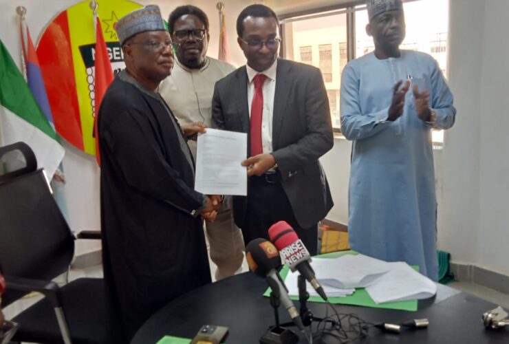 Major General A. Jibril (rtd) and Supo Philips MD Zircon projects exchanging MoU document.