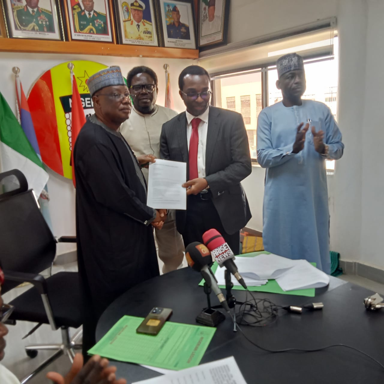 Major General A. Jibril (rtd) and Supo Philips MD Zircon projects exchanging MoU document.