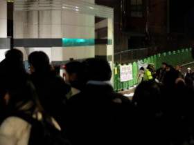 People gather outside an elementary school building in Daejeon, South Korea on Feb. 10, 2025.Yonhap / AFP