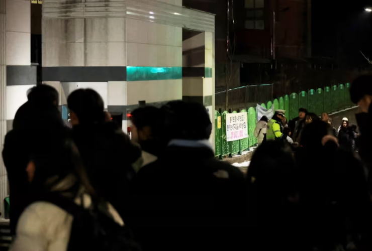 People gather outside an elementary school building in Daejeon, South Korea on Feb. 10, 2025.Yonhap / AFP