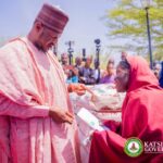 Katsina State Governor distributing cash grants and food items to less privileged women.