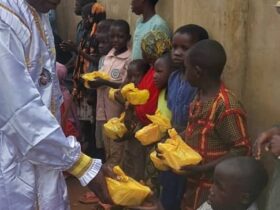 His Most Eminence, Baba-Aladura Bob-Manuel distributing food,money and water.