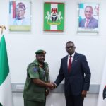 Chief of Military Intelligence Major General Aliyu Abbas Idris,(left,) in hand shake with Efcc Chairman Ola Olukayede