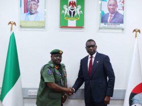 Chief of Military Intelligence Major General Aliyu Abbas Idris,(left,) in hand shake with Efcc Chairman Ola Olukayede