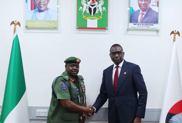 Chief of Military Intelligence Major General Aliyu Abbas Idris,(left,) in hand shake with Efcc Chairman Ola Olukayede