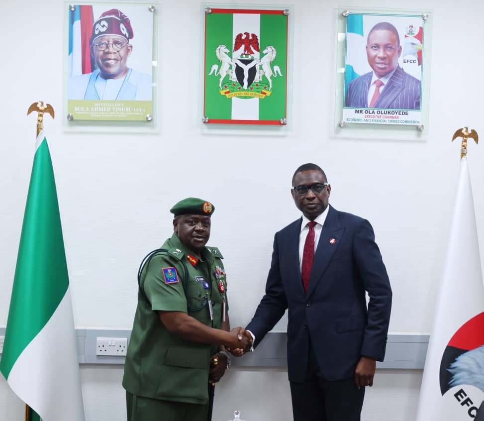 Chief of Military Intelligence Major General Aliyu Abbas Idris,(left,) in hand shake with Efcc Chairman Ola Olukayede