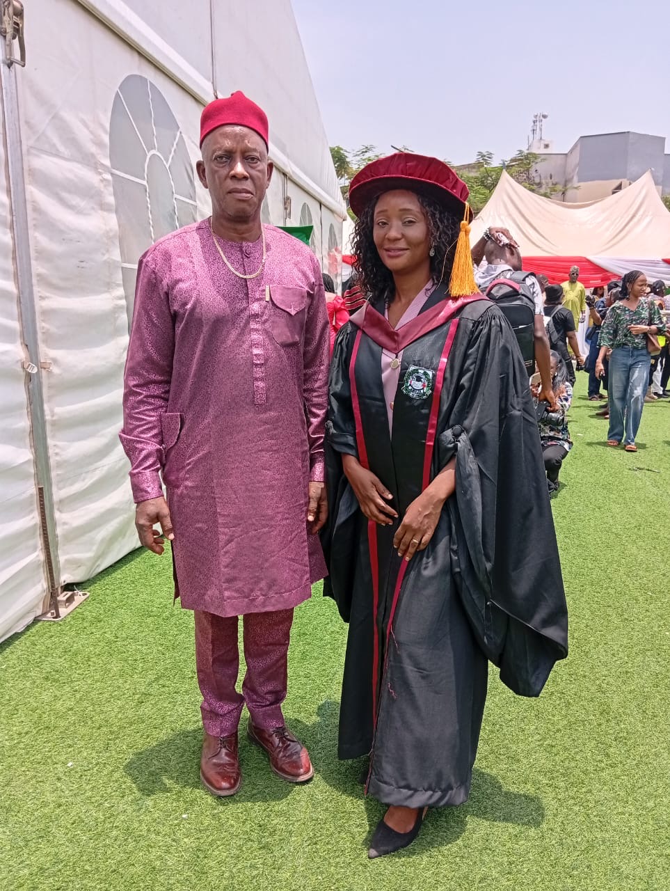 One of the graduates that earned Doctor of Philosophy, Mrs Ifeoma Kate Utalor posed with her father Dr. Azuka Benard the Registrar National Mathematical Central Abuja.